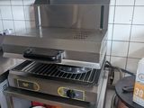 stainless steel counter top with a stove and a pot on it