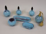 several pieces of blue glass are arranged on a white surface