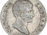 a silver coin with a profile of a man in profile