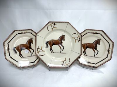 three plates with horses painted on them on a white background