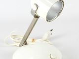 a white lamp that is on top of a table
