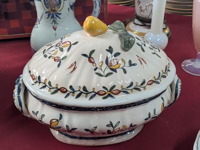 a large white bowl with a lid on a table