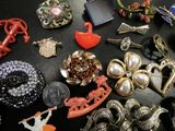 many different types of jewelry on a black table