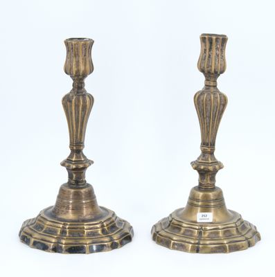 pair of antique brass candlesticks on a white background