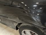 a picture of a car that has been dented and is in a garage