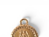 an image of a gold medal with the image of the virgin of guadalupe
