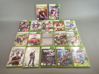 the xbox game collection is displayed on a table in front of a gray background