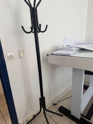 a black coat stand with a coat rack on top of it