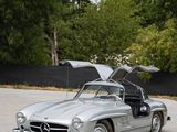 a silver mercedes 300sl is parked in a parking lot
