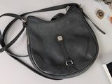 a black purse sitting on a table next to other items