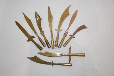 several different types of knives are arranged on a white surface
