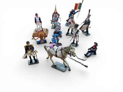 a lot of figurines that are on a white surface