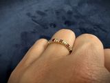 a close up of a person ' s hand with a ring on it ' s finger
