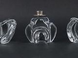 three clear glass vases sitting on top of a black table