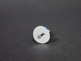 a close up of a white button with a blue stripe on it