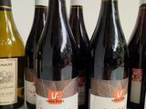 several bottles of wine are lined up on a table