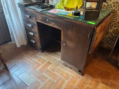 a wooden desk with a glass top in a room