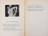 an open book with a picture of a naked woman on it