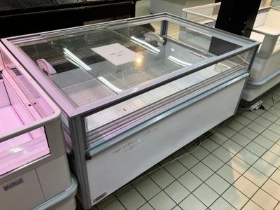 a display case in a store with pink lights