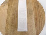 a wooden cutting board with a piece of paper on top of it