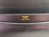 a close up of a black bag with a gold logo on it