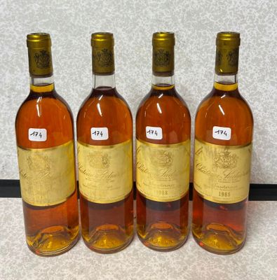 quatre bouteilles de vin sont alignées sur une table