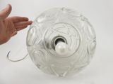 a person holding a light that is in a glass vase