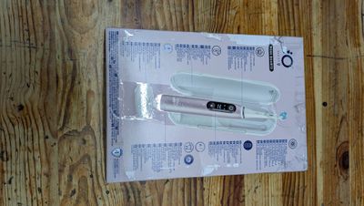 a box with a razor on top of it on a wooden floor
