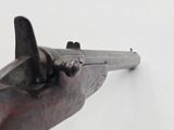 an old gun that is on a white surface with a white background