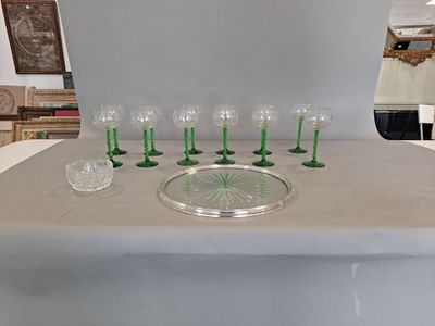 bottles and glasses on a table with a tray on top of it