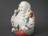 an image of a statue of a laughing man with a bird on his shoulder
