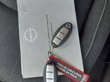 a car key, remote control, and battery in the back seat of a car