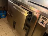 a kitchen that has a lot of stainless steel appliances in it