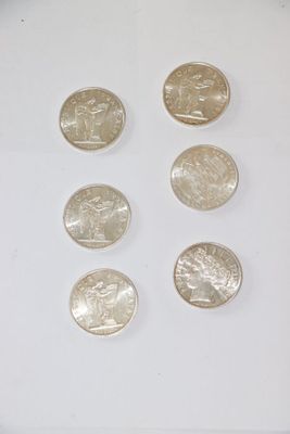 several quarters of silver coins are arranged in a row on a white surface