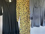 three dresses hanging on a clothes rack in a room