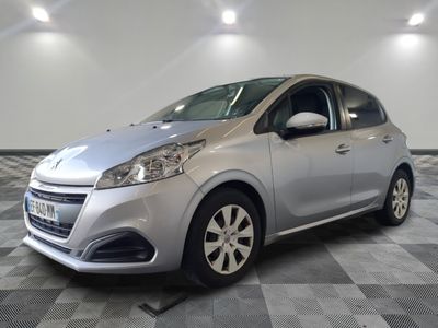 the small silver car is parked in the room on a checkered floor