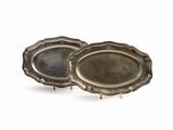 pair of silver plated trays on stands on a white surface