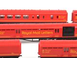 several red train cars are lined up on a white surface