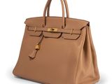 a brown leather handbag on a white background