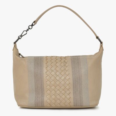 a beige leather bag with a braid design on the front
