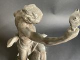 a statue of a boy holding a fish in his hand
