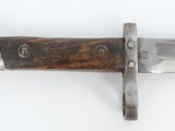 a close up of a knife on a white surface