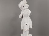 a white statue of a woman with a hat on her head