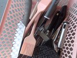 a pink basket filled with kitchen utensils and scrubbers