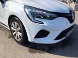 the front end of a white car parked in a parking lot