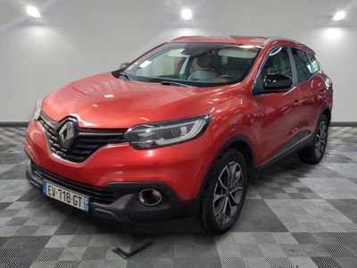 a red car is parked in a room with a checkered floor