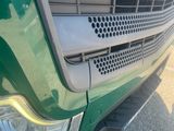 a close up of the grille of a green truck