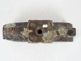 an old piece of metal with a hole in the middle