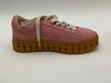 pink sued sneakers with laces and rubber soles on a white background