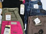 a lot of different colored jeans on a white table